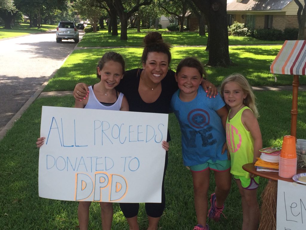 The girls with a supporter. All told, they raised over $10,000 for the Dallas Police Department.