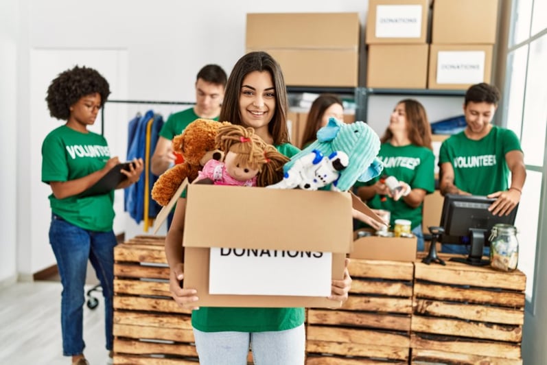 Teenagers collecting donations for a holiday toy drive at a charity center