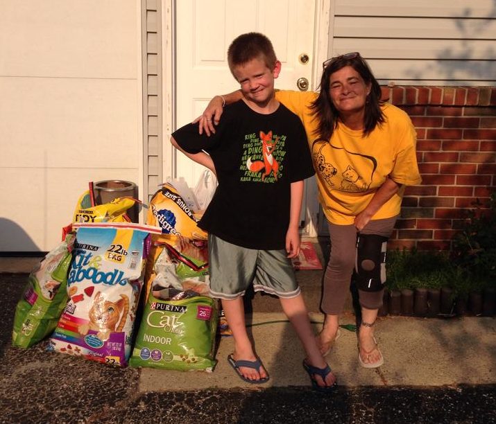 Joanie and her young neighbor, who used all of his birthday money to donate food to the Speedway Animal Rescue.