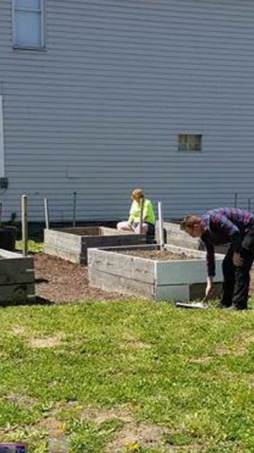 Sherri (left) helping set up some of the first plots for the community garden.