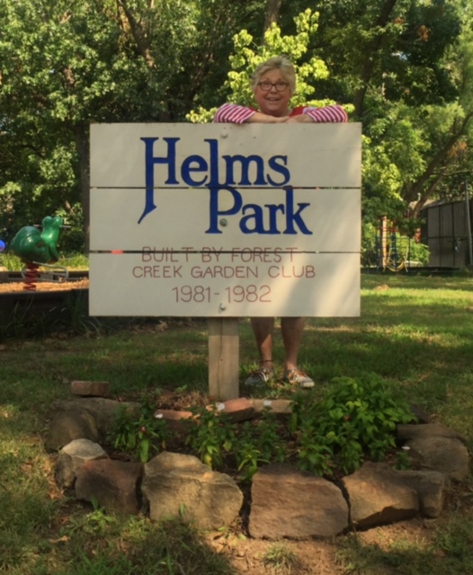 Sherry in front of Helms Park, named after her for her efforts in transforming the vacant lot into a beautiful park next to the swimming pool.